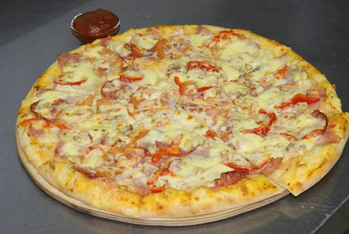 Kefir pizza with cheese and tomatoes in the oven