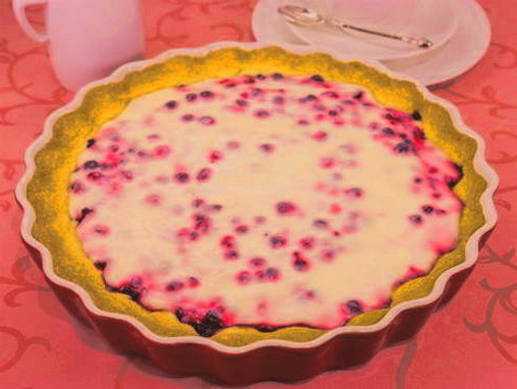 Open pie with lingonberries and sour cream in the oven